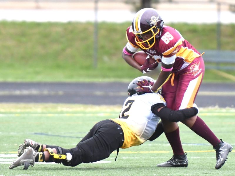 Divas wide receiver Melissa Washington is tackled by Phoenix wide receiver Porschia Holmes during the Divas 41-22 win at Robert E. Lee High School in Virginia on Saturday, May 20. /Photo by John E. De Freitas