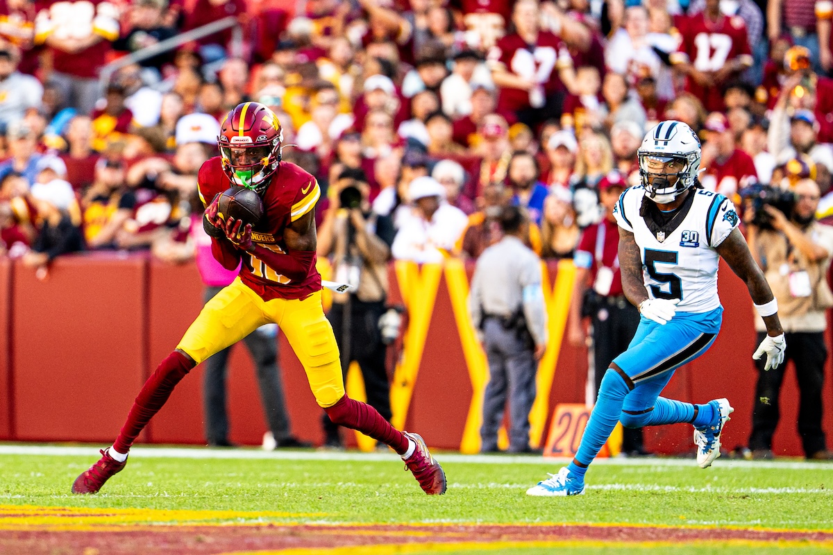 Washington Commanders cornerback Emmanuel Forbes (left) intercepts a pass during the Commanders' 40-7 win over the Carolina Panthers at Northwest Stadium in Landover, Maryland, on Oct. 20. (Abdullah Konte/The Washington Informer)