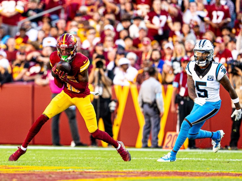 Washington Commanders cornerback Emmanuel Forbes (left) intercepts a pass during the Commanders' 40-7 win over the Carolina Panthers at Northwest Stadium in Landover, Maryland, on Oct. 20. (Abdullah Konte/The Washington Informer)