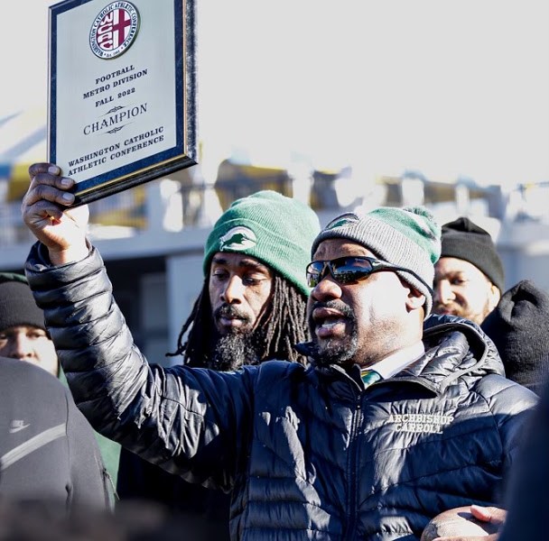 Head coach Robert Harris hoists the championship plaque during the trophy ceremony. (Courtesy of ACHS Jim Vance Media student Jackson Swain)