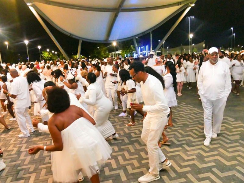 Guests do the electric slide at Le Diner En Blanc-Washington at RFK Stadium on Sept. 21. (Shevry Lassiter/The Washington Informer)