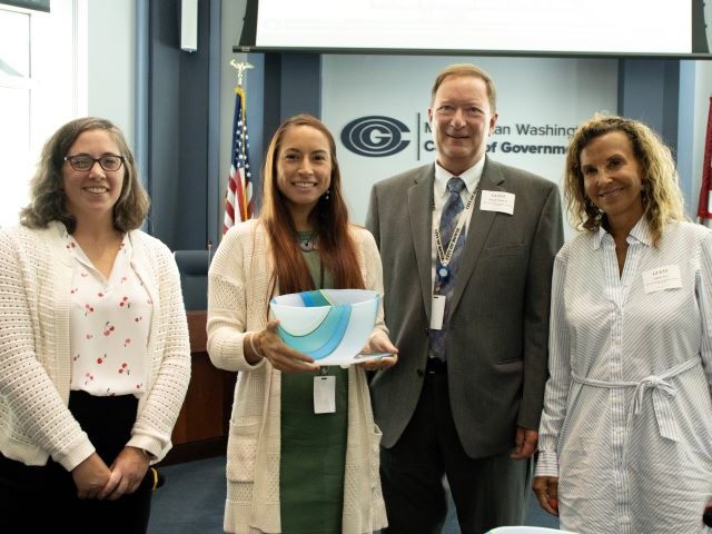 Council of Governments (COG) Air and Climate Public Advisory Committee Vice Chair Julie Kimmel (far left) and COG Climate, Energy, and Environment Policy Committee Chair Jolene Ivey (far right) recognize the City of Bowie’s Food Waste Diversion Program as one of the 2024 Climate and Energy Leadership awardees. (Courtesy Photo/Metropolitan Washington Council of Governments)