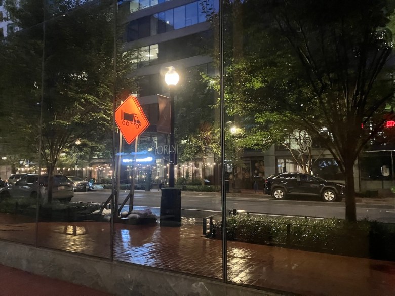 A “problem building” near Mount Vernon Square mirrors the street around it. Many birds struggle to see glass when it’s completely transparent or highly reflective. (Kayla Benjamin/The Washington Informer)