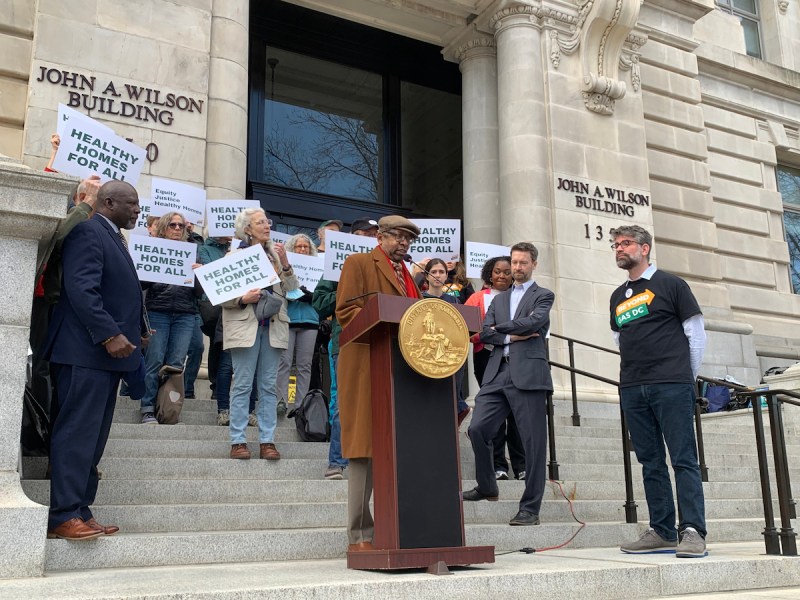 Bill Washburn, NAACP DC’s Climate Justice Chair, speaks in support of the Healthy Homes Act among a group of advocates who gathered on the steps of the Wilson Building on March 12, three weeks before the D.C. Council passed the bill. (Kayla Benjamin/The Washington Informer)