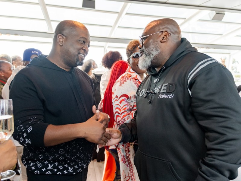 Shawn Townsend, president and CEO of the Restaurant Association of Metropolitan Washington, chats with Corey Arnez Griffin, president of the Greater Washington DC Black Chamber of Commerce, at the Anacostia Coordinating Council boat ride on Oct. 5. (Ja'Mon Jackson/The Washington Informer)