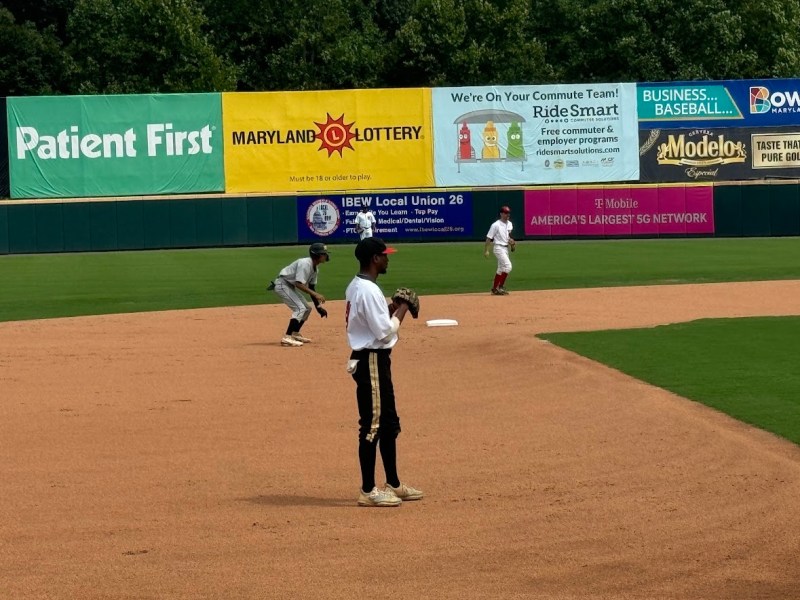 Players anticipate a batter's swing in the midfield. (Anthony Tilghman/The Washington Informer)