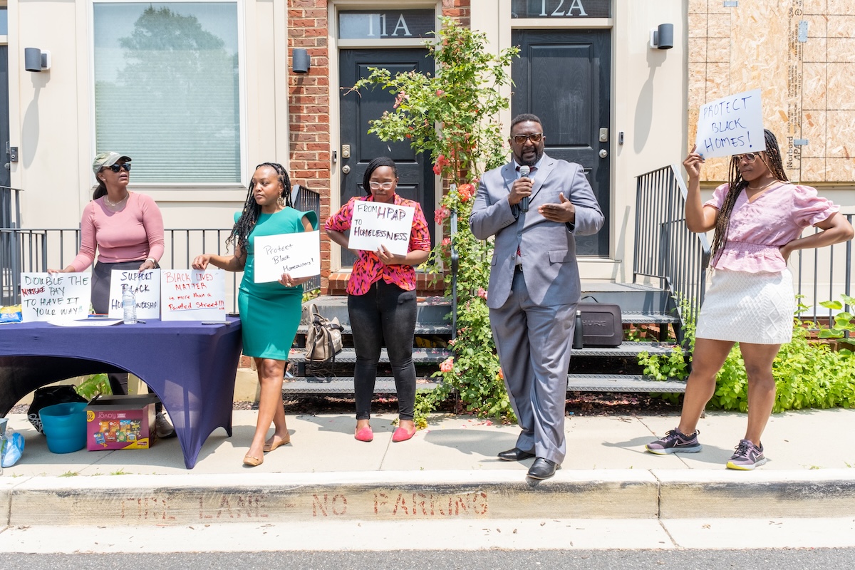 After nearly four years of fighting for recompense, rallying (as pictured here in May 2023) and contentious mortgage relief negotiations, most, if not all, of the owners of condemned condominiums on Talbert Street in Southeast have received mortgage relief. However, there is still work to be done to ensure beleaguered homeowners can afford to settle elsewhere in the District. (WI File Photo)