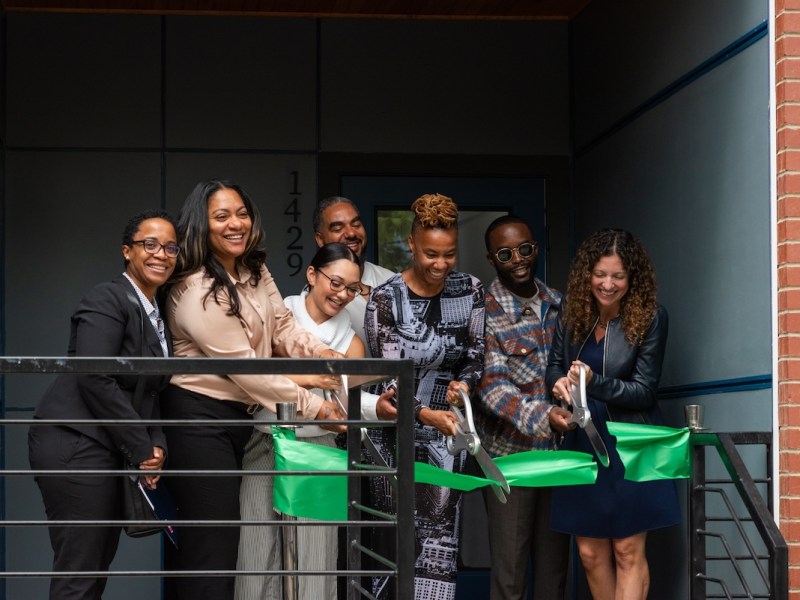 Ayesha Hudson and Trisha Miller cut the ribbon to celebrate the completion of the units in Ward 8. (Courtesy of the DC Sustainable Energy Utility)