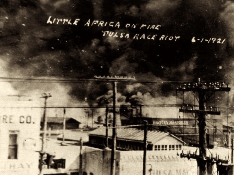 In this postcard from the collection of McFarlin Library at the University of Tulsa, a photo from on top of the Santa Fe Freight office at 1st Street and Elgin Avenue in Tulsa, Oklahoma, is seen, showing the fires on Archer towards Greenwood. The Goodner-Malone company (1 N. Frankfurt) building is in the center of the photo. (Courtesy of Wikimedia Commons)