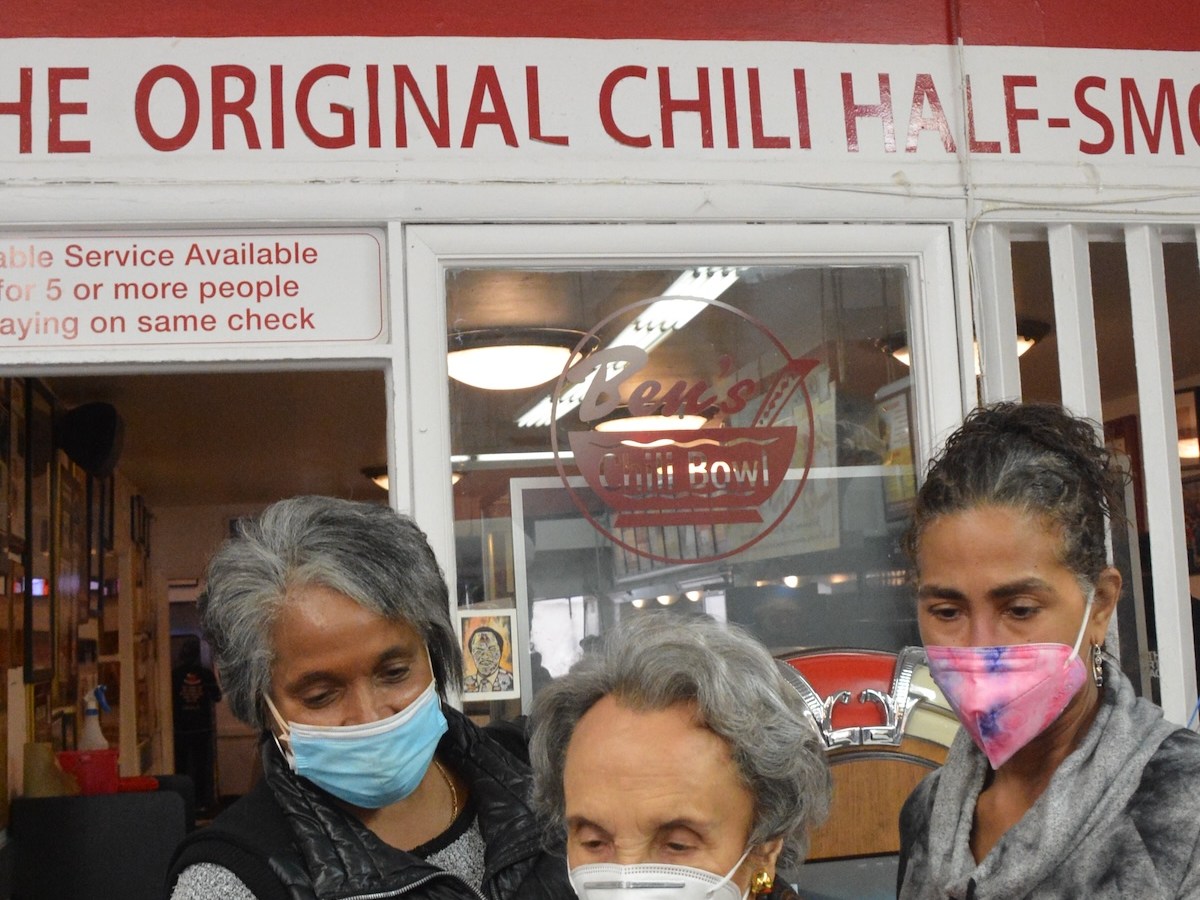 **FILE** Kitty Chaney, Virginia Ali and Sonya Ali read The Washington Informer at Ben’s Chili Bowl. In its 60th year, Virginia Ali says The Washington Informer is an important publication that should keep going. (Roy Lewis/The Washington Informer)