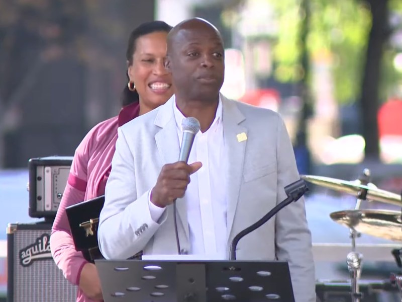 Washington Commanders franchise legend Darrell Green speaks during an Oct. 19 in Washington, D.C.'s Franklin Park at which Mayor Muriel Bowser (left) presented him with a ceremonial key to the city.