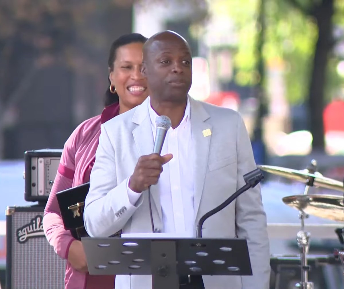 Washington Commanders franchise legend Darrell Green speaks during an Oct. 19 in Washington, D.C.'s Franklin Park at which Mayor Muriel Bowser (left) presented him with a ceremonial key to the city.