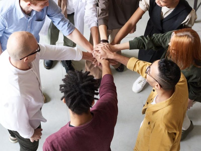 photo of people holding each other s hands