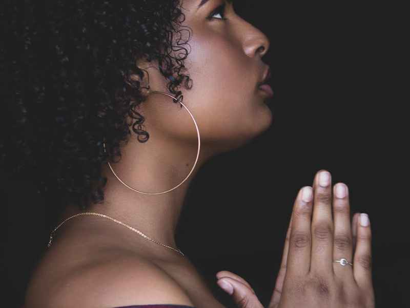 woman in red top praying