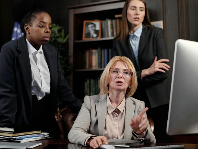 female lawyers in an office looking at a computer