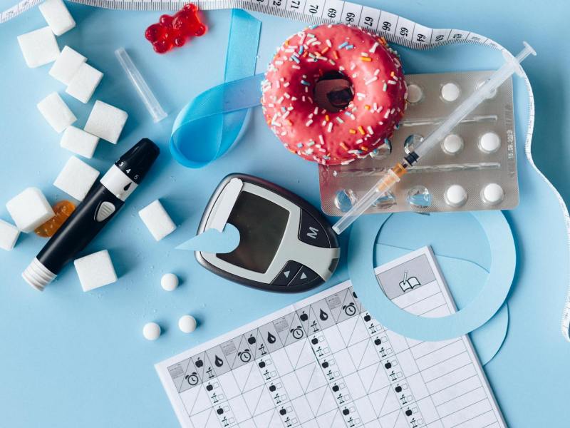 blood sugar meter and medication on the blue background