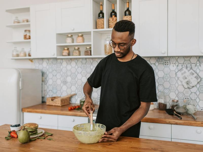 a man mixing batter in a bowl