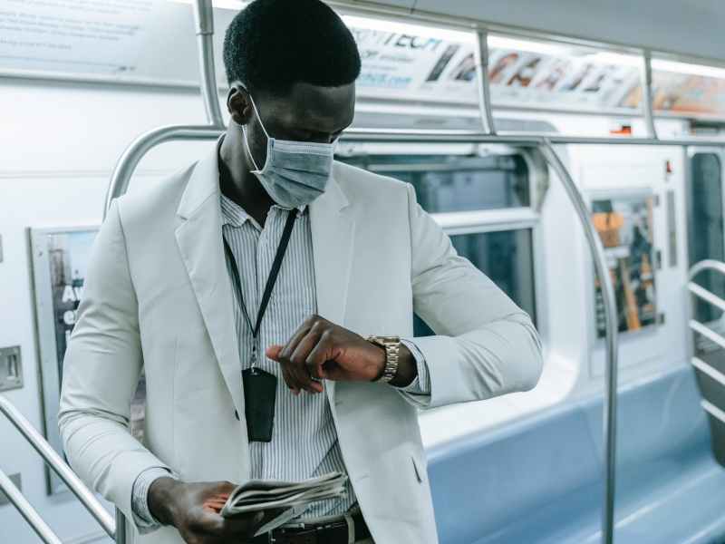 man looking at watch in metro train