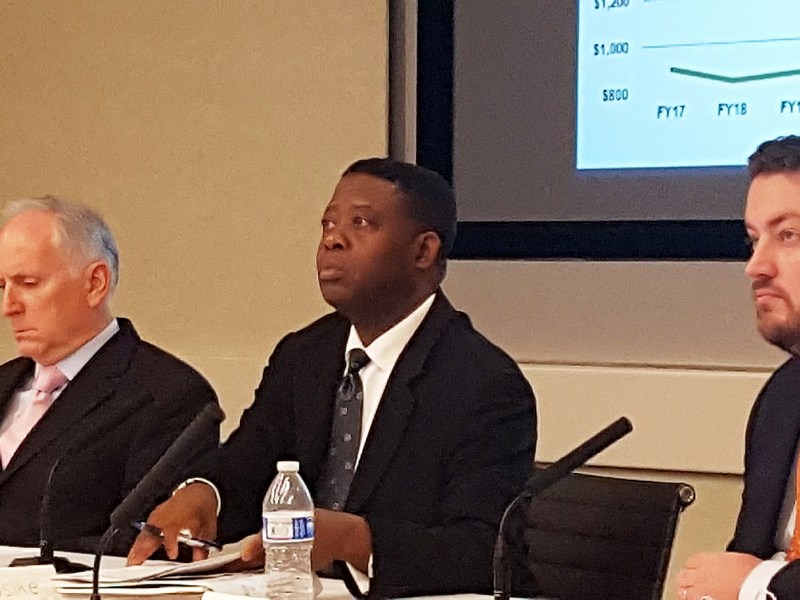 Metro Chief Financial Officer Dennis Anosike (center) briefs the agency's finance committee on Oct. 13 about its $275 million budget shortfall. /Photo by William J. Ford