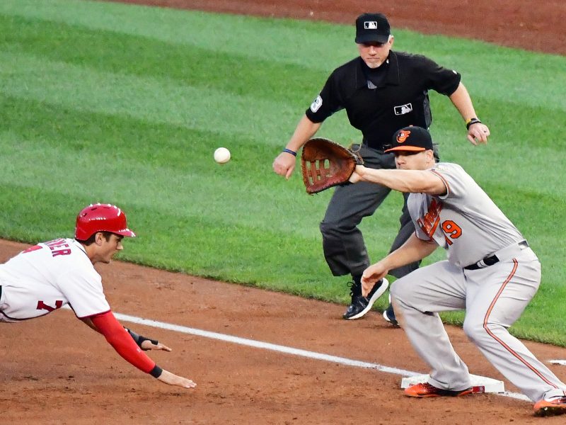 Washington Nationals center fielder Trea Turner slides back to first base as Baltimore Orioles first baseman Chris Davis awaits a pickoff attempt during the Orioles' 10-8 win over the Washington Nationals on Wednesday, Aug. 24 at Nationals Park in southeast D.C. /Photo by John E. De Freitas